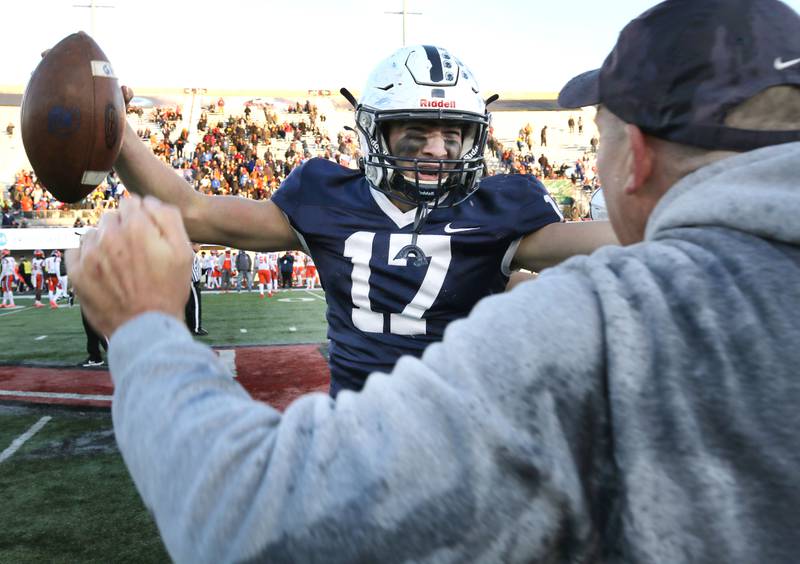 Cary-Grove's Jameson Sheehan hugs coach Brad Seaburg after their 37-36 win over East St. Louis in the Class 6A state championship Saturday, Nov. 27, 2021, in Huskie Stadium at Northern Illinois University in DeKalb.