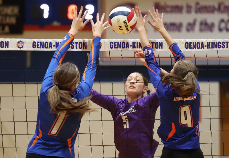 Rochelle's Audyn Kemp tips the ball between Genoa-Kingston's Katelyn O'Carroll (left) and Annabelle Peters during their match Monday, Sept. 15, 2025, at Genoa-Kingston High School.