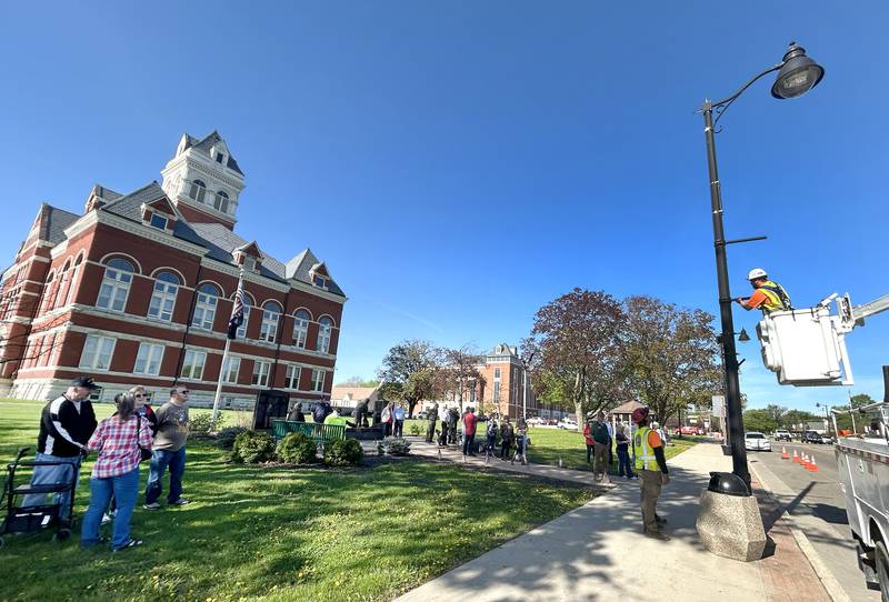 Veterans and their families along with city officials gathered on the Ogle County Courthouse Square to watch the installation of the first Hometown Hero banner on Thursday, April 23, 2026 in downtown Oregon. Twenty banners featuring photos of local veterans are scheduled to be installed around the courthouse square along state highways 64 and 2.