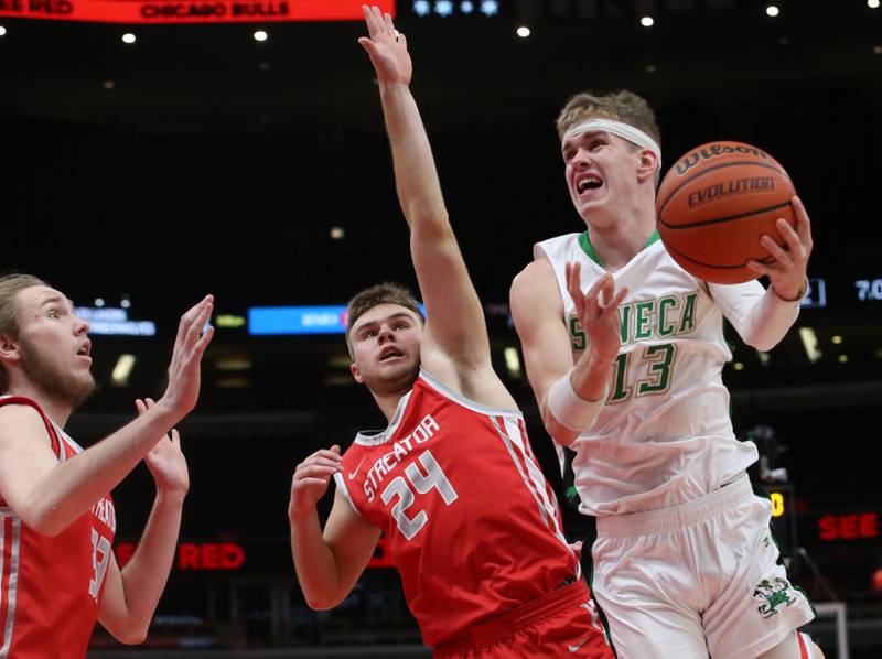 Seneca's Paxton Giertz eyes the hoop as he is met in the lane by Streator's Landon Muntz and teammate Quinn Baker during a game on Tuesday, Dec. 21, 2023 at the United Center in Chicago.