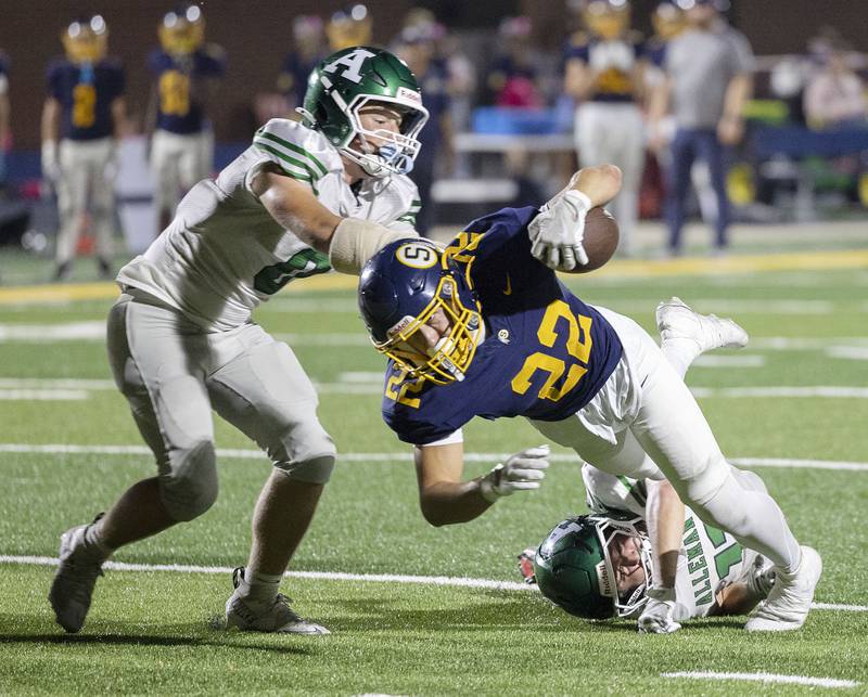 Sterling’s Brady McCray is tripped up by Alleman’s Jacob Moore Friday, Oct. 3, 2025.