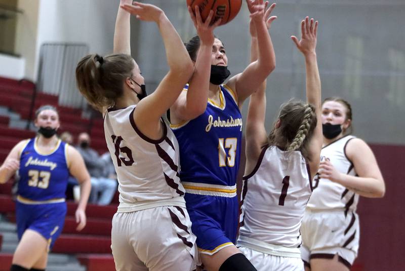 Johnsburg’s Macy Madsen navigates through traffic under the hoop during girls varsity basketball action in Marengo Thursday night.