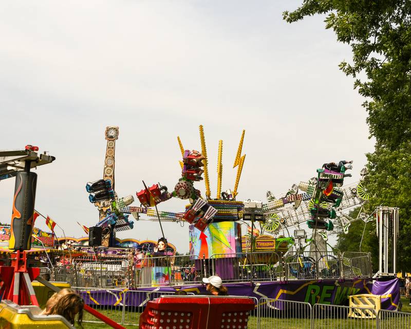 Community members enjoy carnival rides on a humid day before a storm rolled through Elburn Days.