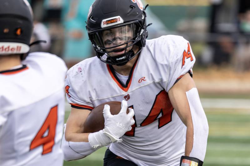 Washington's Camden Westerfield picks-up yardage during a 5A varsity football playoff game against Providence at Providence on Nov. 15, 2025.