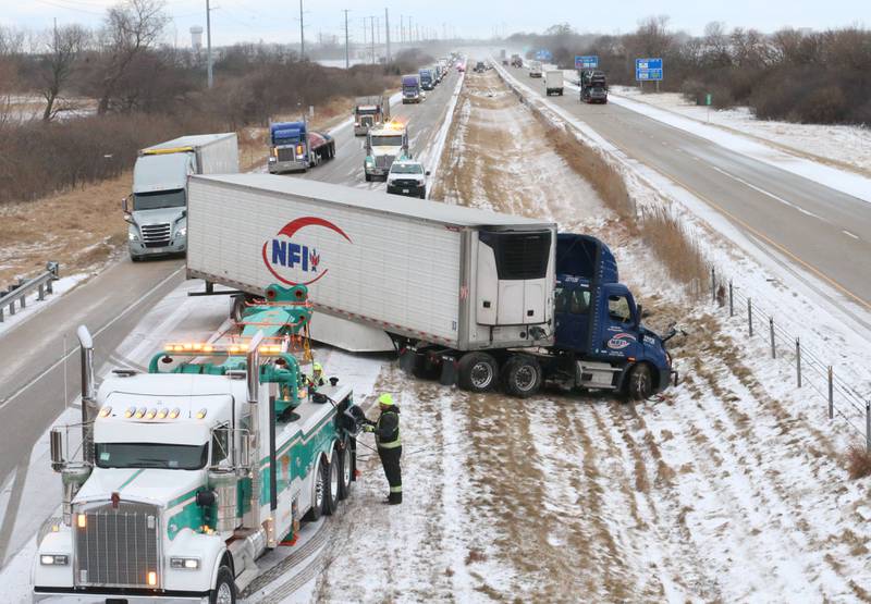 Crews with Senica's Towing pull a semi truck out of the median in the eastbound lane of Interstate 80 near mile marker 82 on Wednesday, Jan .14, 2026 near Utica. Multiple semi tractor trailers were reported in the median between Utica and Ottawa. Interstate 80 remained closed while crews could remove the wreckage from the accident scenes. A fast moving squall line with gusty winds and snow near white-out conditions caused the wrecks.