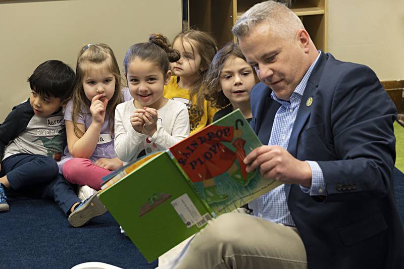 Congressman and meteorologist Eric Sorensen reads a book chosen by the preschool class Wednesday, March 27, 2024 to students in the Head Start program at Wallace School in Sterling. Sorensen toured the school to ask how he can help strengthen the early childhood education program.