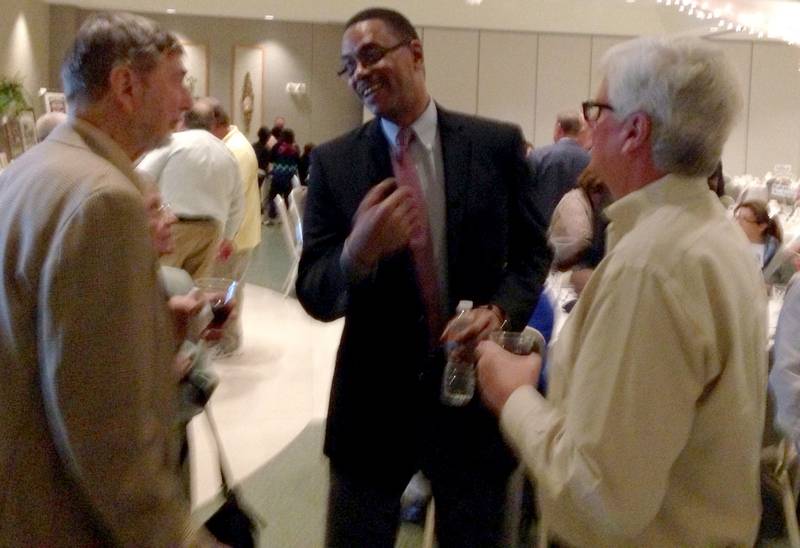 Larry Parker (center) talks with Bill Edwards (left), his former basketball coach at Joliet West, and with his former teammate, Craig Spiers, during last Thursday's Night of Champions.