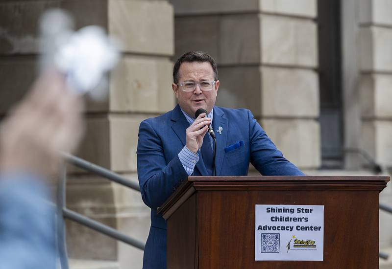 Lee County Judge Matthew Klahn speaks about his work with Shining Star Children’s Advocacy Center Friday, April 10, 2026, during the Hands Around the Courthouse event.