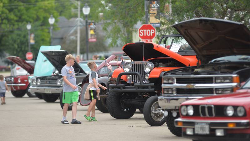 Two kids check out cars and trucks at the Let Freedom Ring car show on Saturday, July 5, 2025.