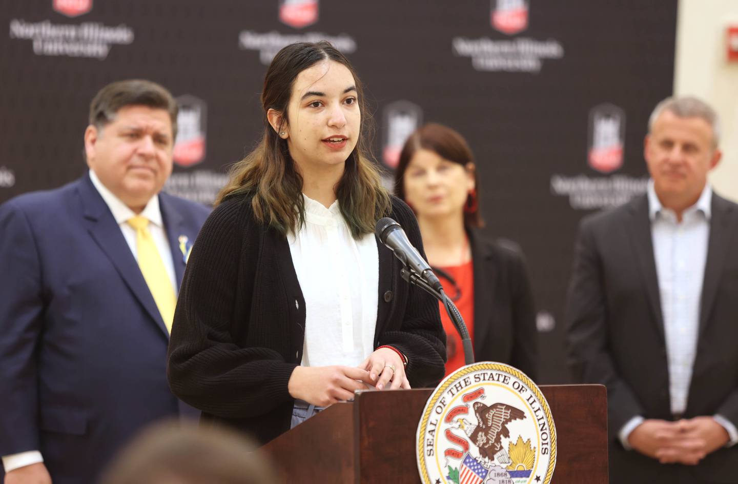 Northern Illinois University student Rebekah Gonzalez talks about her educational journey as Illinois Gov. JB Pritzker looks on Thursday, March 3, 2022, in the Barsema Alumni and Visitors Center at NIU in DeKalb. Pritzker was visiting NIU to talk about the importance of higher education and to tout the programs in Illinois that make that education more accessible to all.