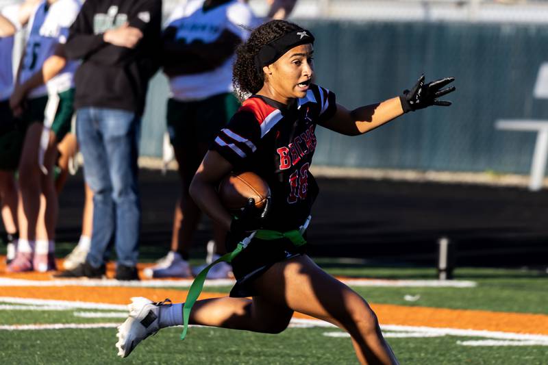 Bradley-Bourbonnais's Nia Lawrence runs the ball before scoring a touchdown during a varsity flag football Romeoville Regional semifinal game against Plainfield Central at Romeoville on Oct. 7, 2025.