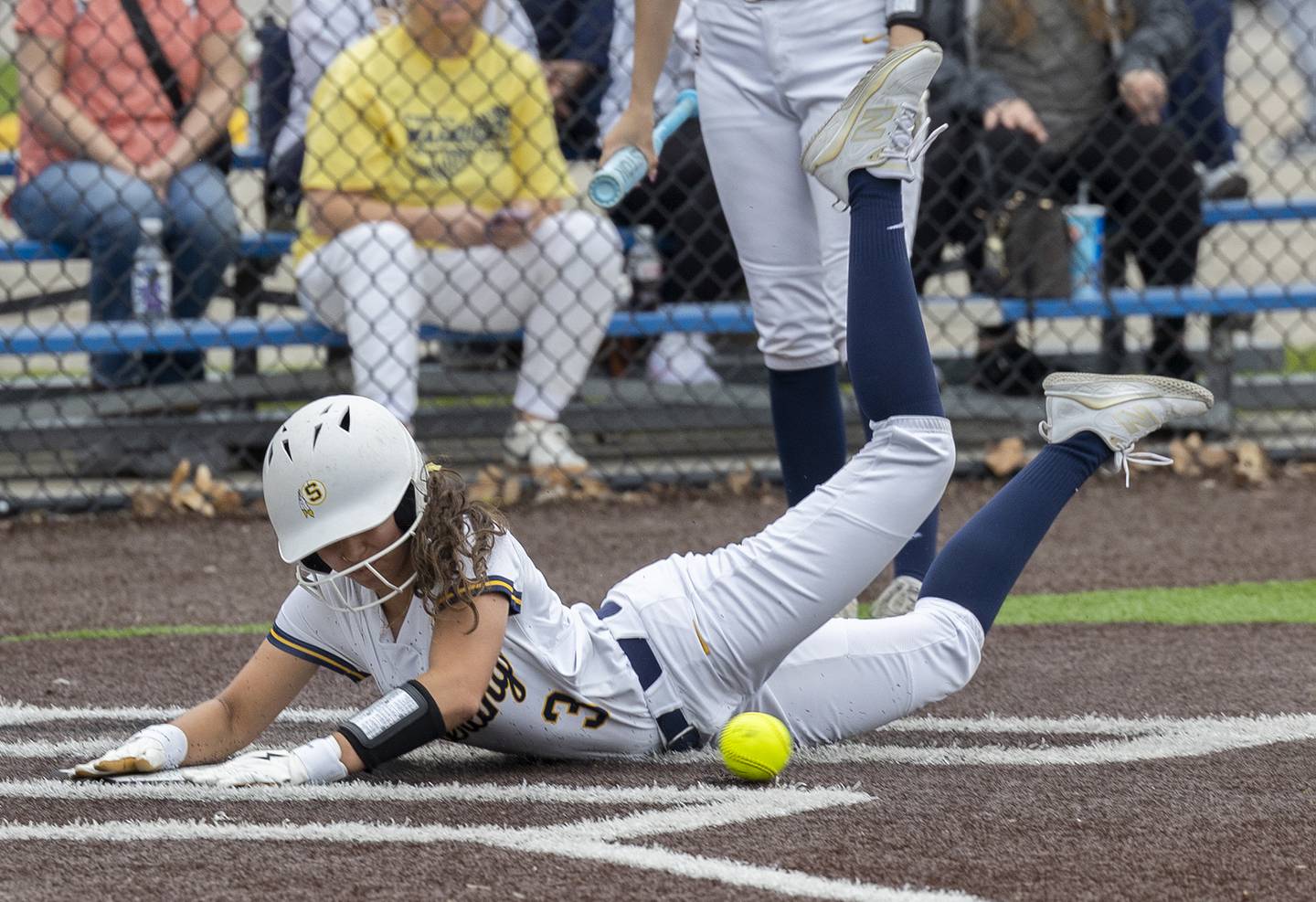 Sterling’s Lily Cantu dives in at home for a steal against Moline Tuesday, April 22, 2025.