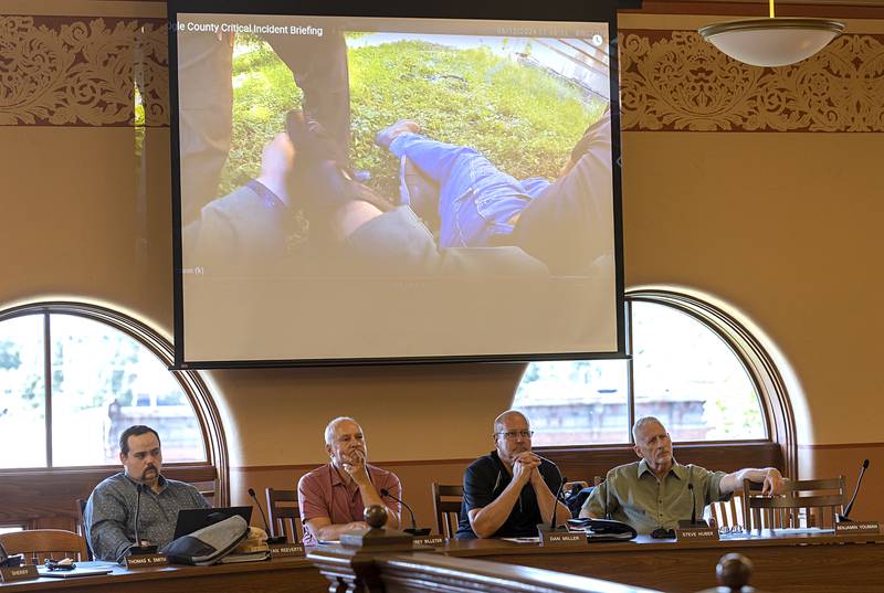 Ogle County board members watch body cam video Tuesday, June 18, 2024 from last week’s shooting at Lost Lake. Sheriff Brian VanVickle presented the board with the video.
