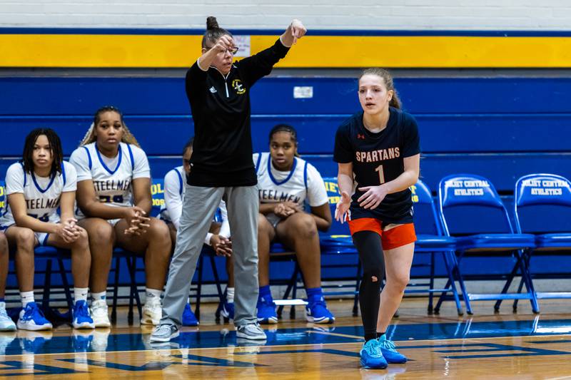 Romeoville's Kacey Foust signals for the ball during a varsity girls basketball game against Joliet Central at Joliet Central on Dec. 18, 2025.