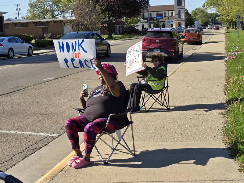 Inspired by an Easter Day shooting in Streator that resulted in the death of a 17-year-old, residents hold signs Tuesday, May 6, 2025, at Streator's City Park to promote peace.