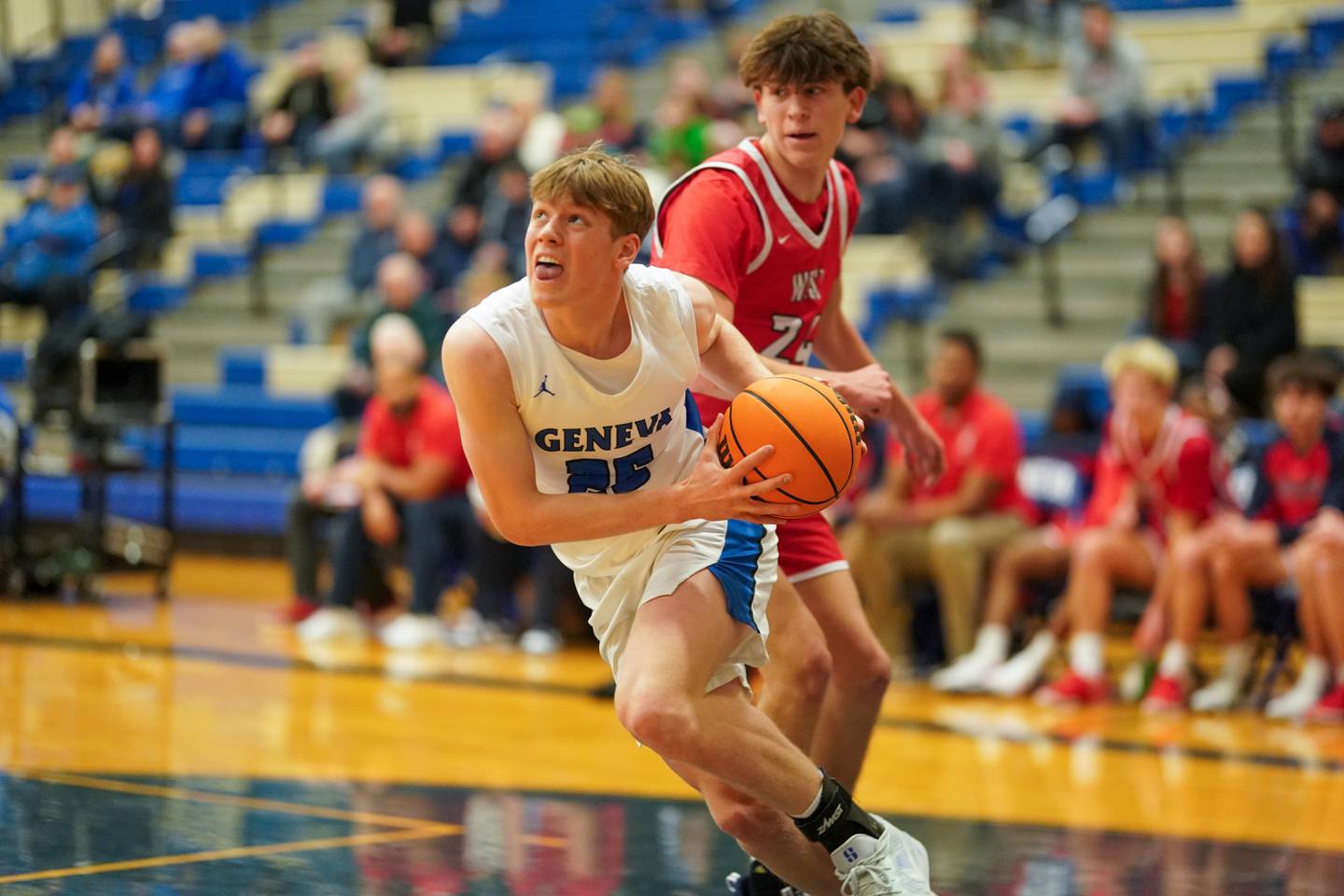 Geneva’s Hudson Kirby (25) drives the baseline against West Aurora's Gabriel Gonzales (24) during a MLK Day of Hoops basketball game at Geneva High School on Monday, Jan. 20, 2025.