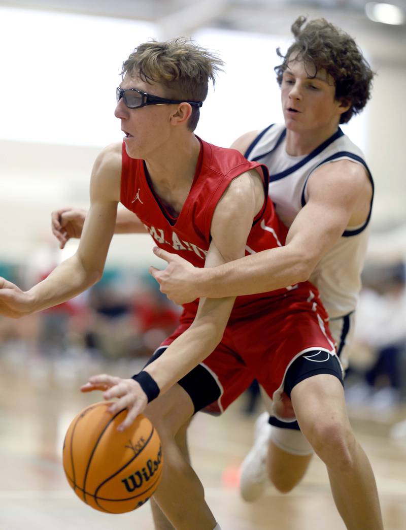 Palatine’s Darrin Dick (22) heads to the hoop past Downers Grove South’s Wyatt Wawro (5) during the Jack Tosh Holiday Tournament Thursday, Dec. 26, 2024 at York High School in Elmhurst.