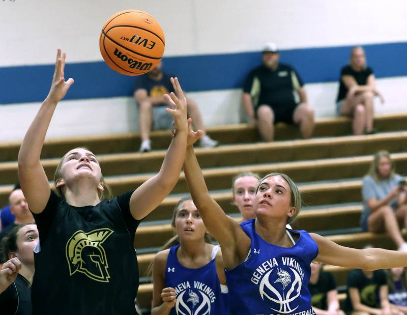 Sycamore’s Macy Calendo (left) grabs a rebound in front of a Geneva player Thursday, June 12, 2025, in the Geneva High School Varsity Summer League.