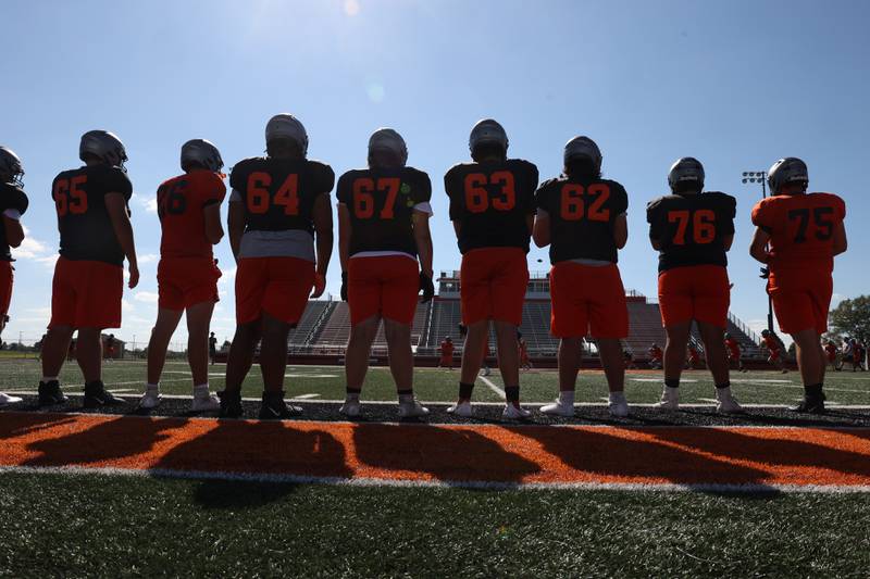 Minooka’s linemen stand on the sidelines during kickoff at practice on Wednesday. Wednesday, Aug. 10, 2022, in Minooka.