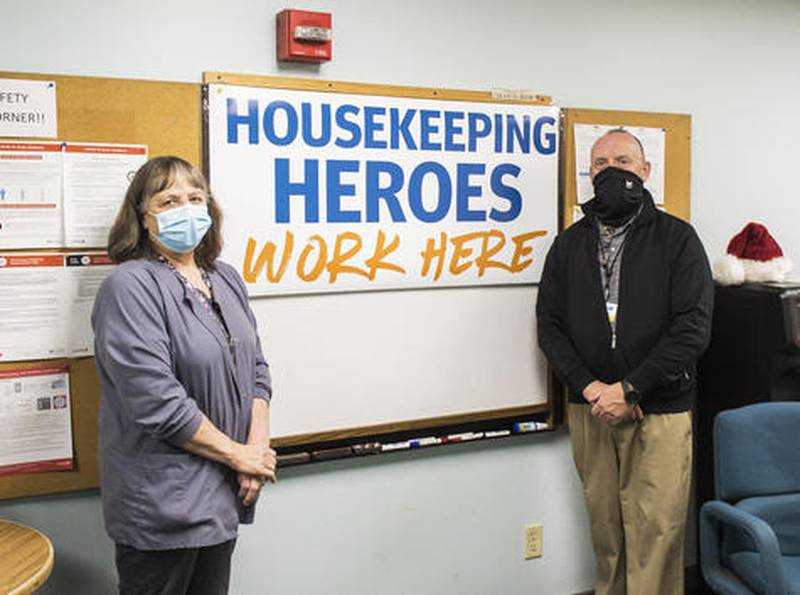 KSB lead housekeeper, Pam Mohr and housekeeping director, Jamey Postlewaite, stand near a housekeeping heroes sign Friday. Housekeeping along with other staff at hospitals have been on the front lines of the coronavirus pandemic.