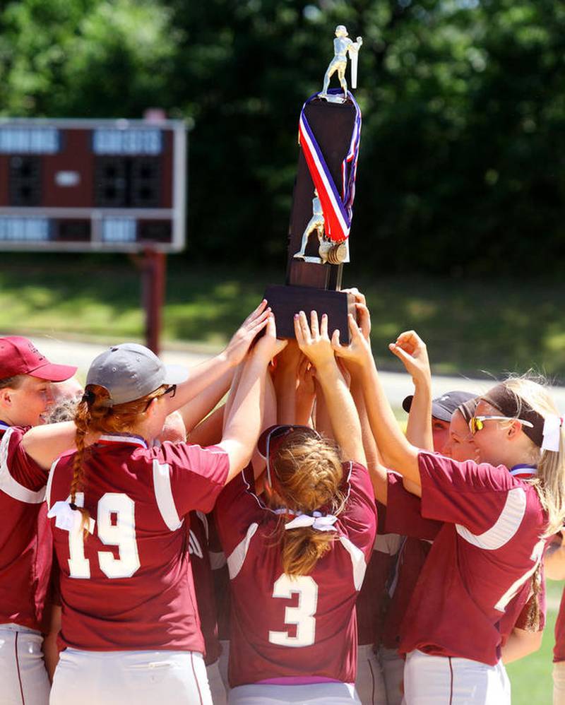 Members of the Marengo softball team hoist their championship trophy during the awards ceremony at Saturday's IHSA Class 3A state championship. The Indians defeated East Peoria, 2-0, to win this year's Class 3A state title.