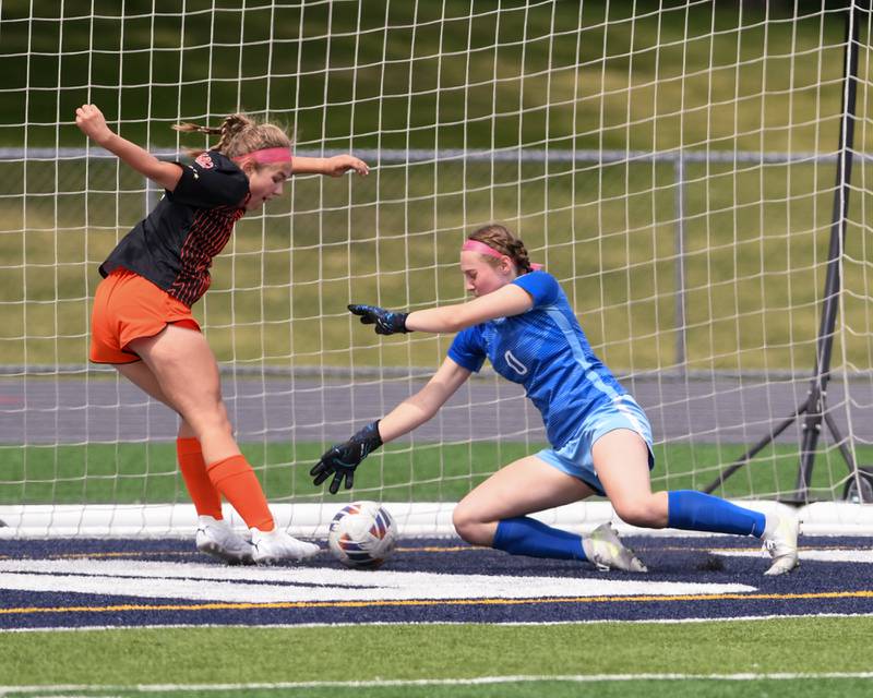 St. Charles East Taum Smith, left, gets the ball past St. Charles North goalkeeper Kara Claussner for a goal during the overtime portion of the sectional title game on Saturday May 27th held at West Chicago Community High School.