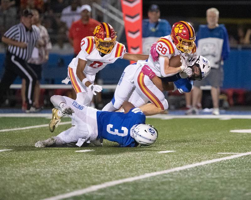 Batavia's Henryt Hah is tackled by Geneva's Dylan Alcaraz on Friday, Oct. 3, 2025 in Geneva.