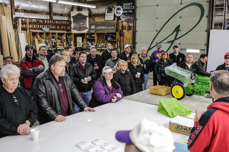 Members of the Plainfield Lions Club gather Saturday before dispersing to deliver gift certificates to families in need.