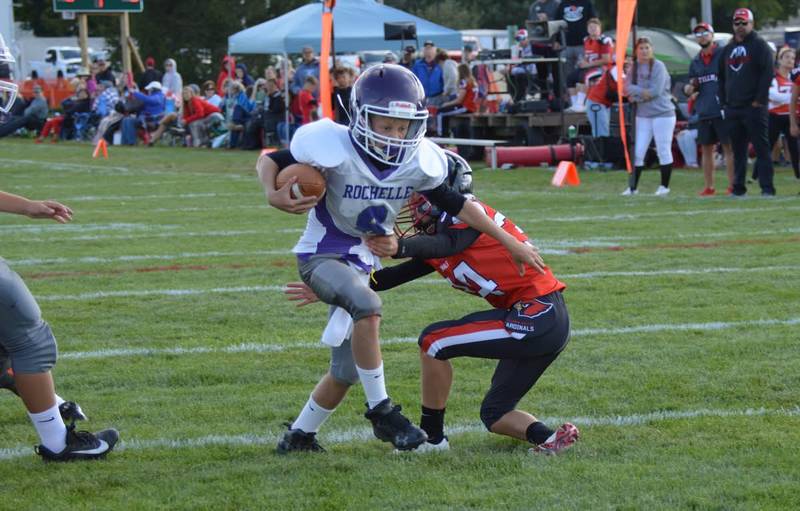 Rochelle quarterback Brecken Bruns slips by four tacklers on a 2-point conversion during a fifth-grade junior tackle football game with Stillman Valley on Sunday, Sept. 7, 2025. Rochelle won 30-0.