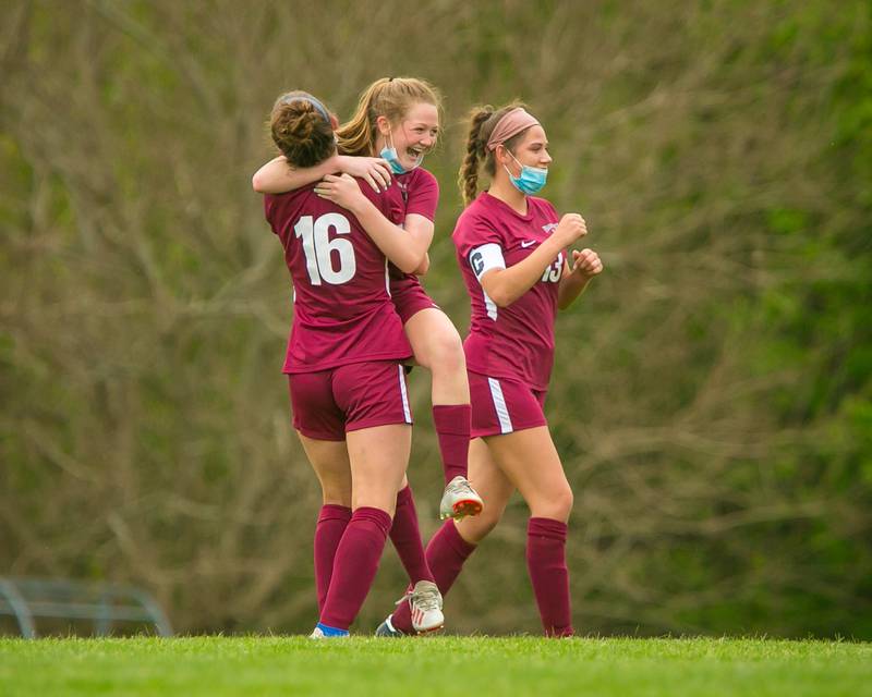 Prairie Ridge's Ellie King (7) smiles in the embrace ofDelaney Todd (16) after the match at Prairie Ridge High School on Tuesday, May 18, 2021, in Crystal Lake, Ill. The Lady Wolves won, 1-0.