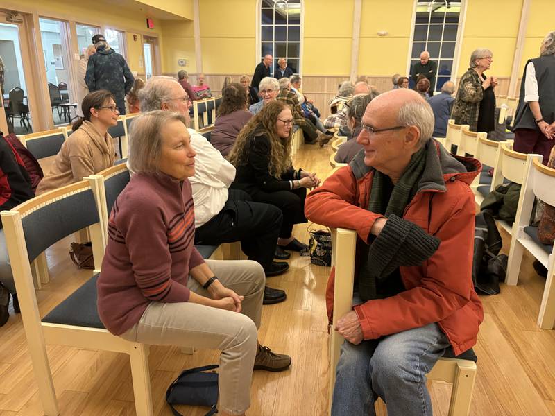 Shari Chakoian, left, and Bill King talk during FaithBridge's Thanksgiving program Nov. 23, 2025 in Crystal Lake.