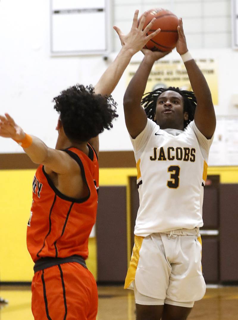 Jacobs' Emaan Thomas shoots the ball over McHenry's Adam Anwar during a Fox Valley Conference boys basketball game on Wednesday, Nov. 29, 2023, at Jacobs High School in Algonquin.