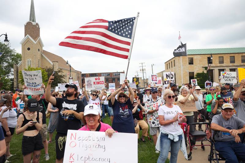 A protester waves an American flag as approximately 500 people gathered at the Kankakee County Courthouse for a ‘No Kings’ rally in Kankakee on Saturday, June 14, 2025, to protest actions by President Donald Trump.