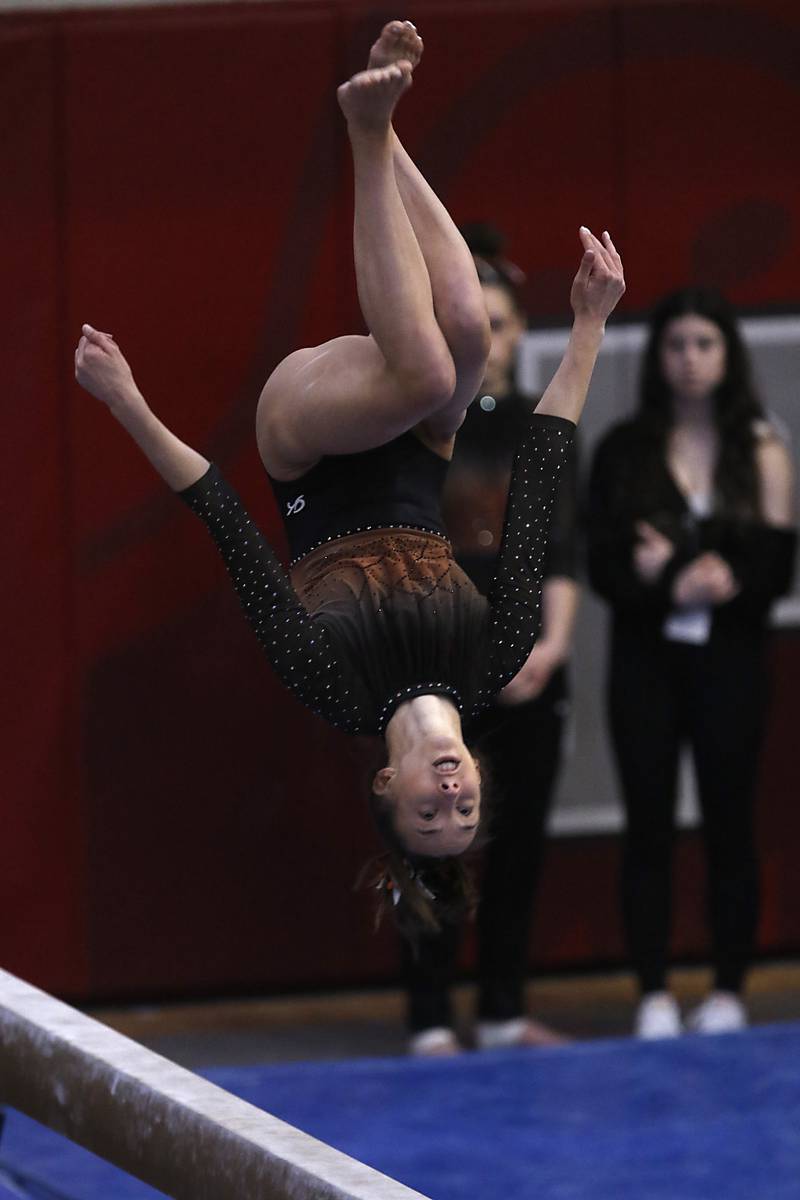 Libertyville’s Anna Baker competes in the preliminary round of the balance beam Friday, Feb. 17, 2023, during the IHSA Girls State Final Gymnastics Meet at Palatine High School.