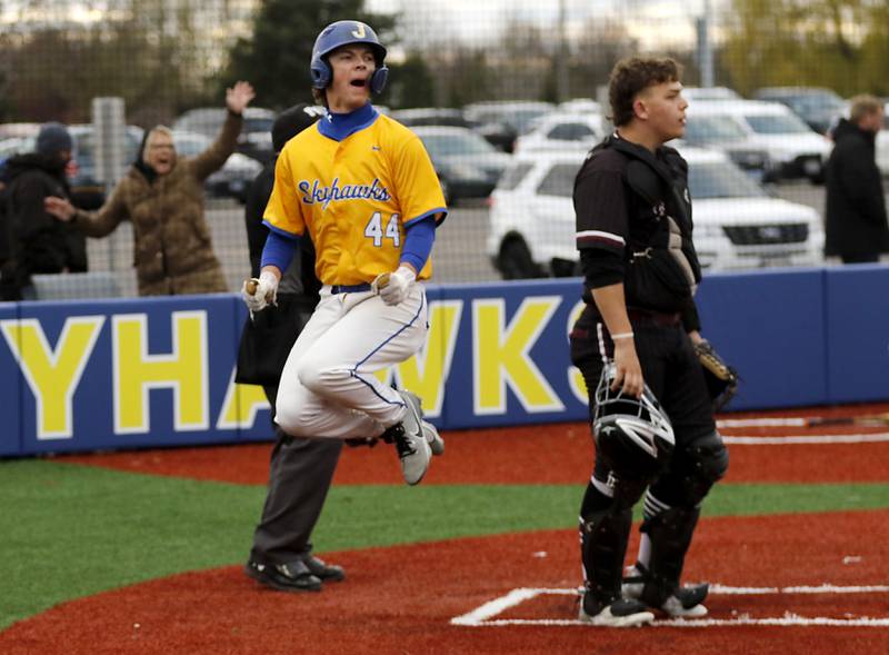 Johnsburg's Evan Pohl  celebrates the game winning run after the infield umpire calls Marengo's Alexander Johnson for a bulk in the seven inning that allowed Pohl to score during a Kishwaukee River Conference baseball game on Monday, April 21, 2025, at Johnsburg High School.