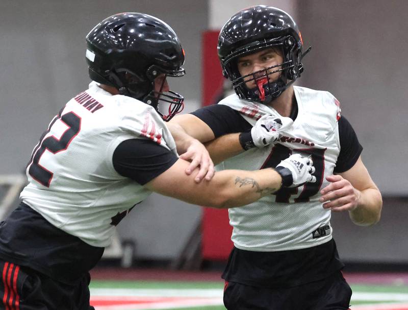 Northern Illinois’ Tanner Phelps (left) and Eliot Hummer participate in a drill Wednesday, July 30, 2025, at the teams first practice of the season in the Chessick Practice Center at NIU in DeKalb.