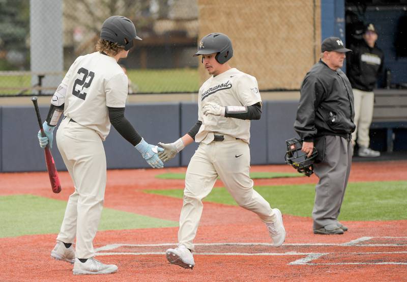 Streamwood's Austin Paskewic (22) congratulates  Miguel Rodriguez (10) on scoring against Marengo during a game on Monday, March 25, 2024 in Carol Stream.