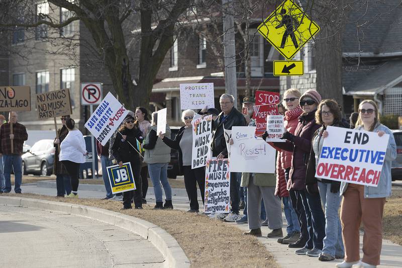 Protestors line up along East Fourth Street in Sterling on Tuesday, Feb. 25, 2025, to express their displeasure for the current presidential administration.