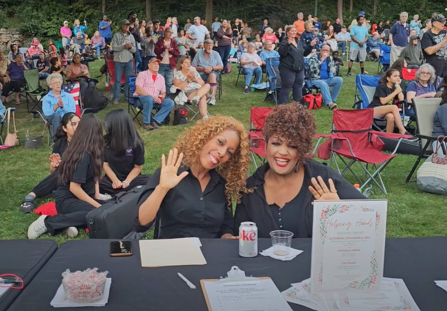 Brandye Phillips (left) executive director of the Joliet-based Helping Hands Family Outreach Inc., enjoys "Concerts on the Hill" at the Billie Limacher Bicentennial Park Theatre with her mother Gloria Phillips (right). Helping Hands is hosting a fundraiser Saturday at Bicentennial Park to raise money for winter coats for children in need.