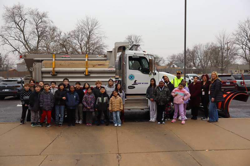 Students from Pershing Elementary School in Joliet stand alongside the newly named Blizzard Wizard city snow plow. The city of Joliet in January invited students with Joliet Public Schools District 86  to submit names for city snow plows.