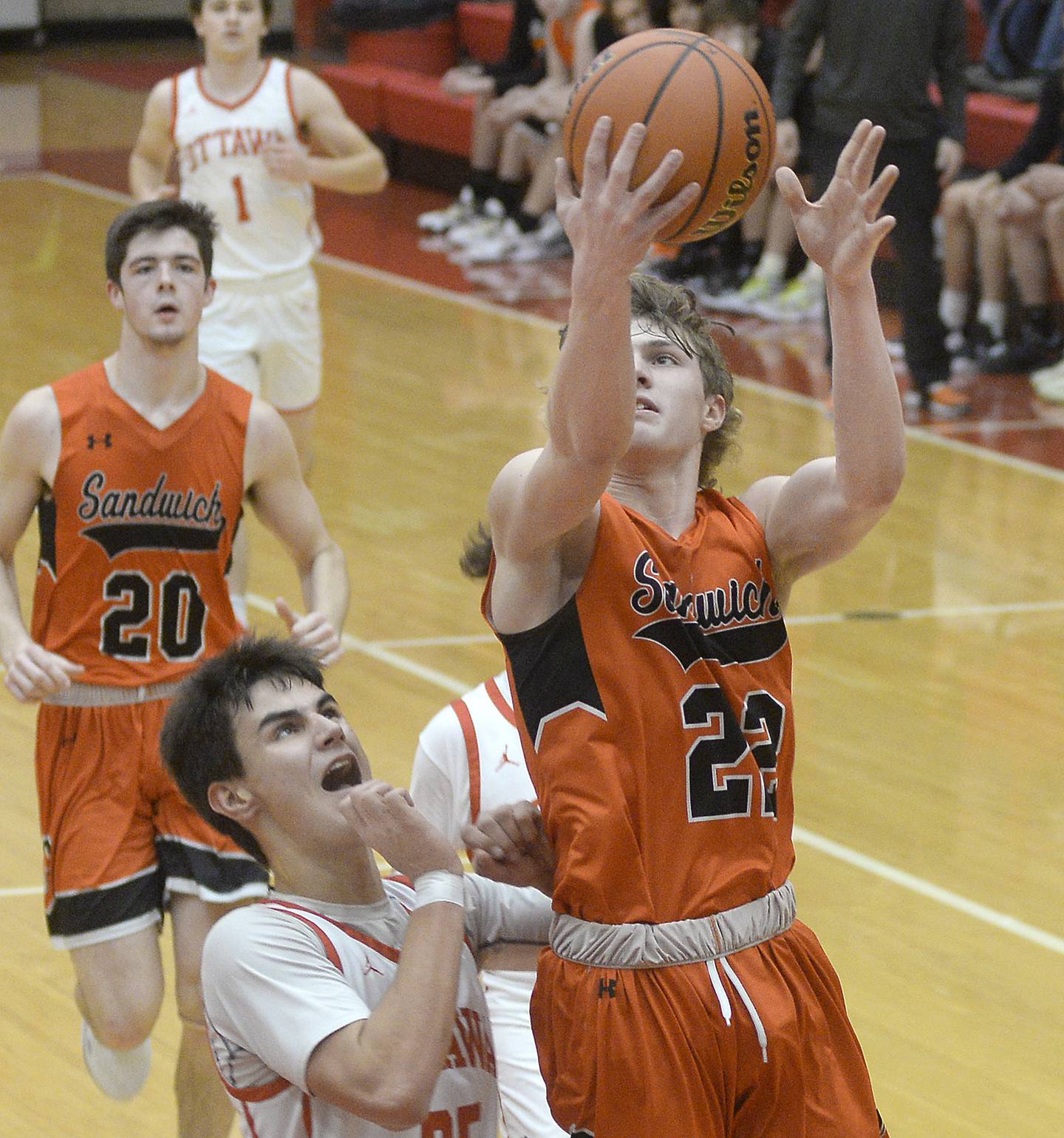 Sandwich’s Austin Marks goes up and over Ottawa’s Payton Knoll to score in the second period on Tuesday, Jan. 3, 2023 at Ottawa High School.