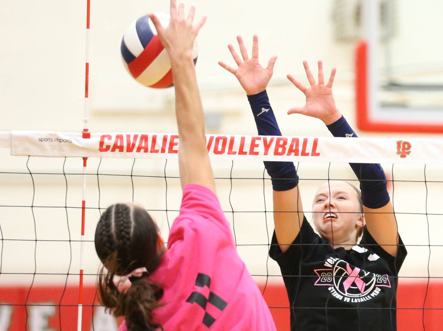 Ottawa's Skylar Dorsey attempts to block an attack by La Salle-Peru's Anna Riva in a match this past season at AJ Sellett Gymnasium in La Salle.