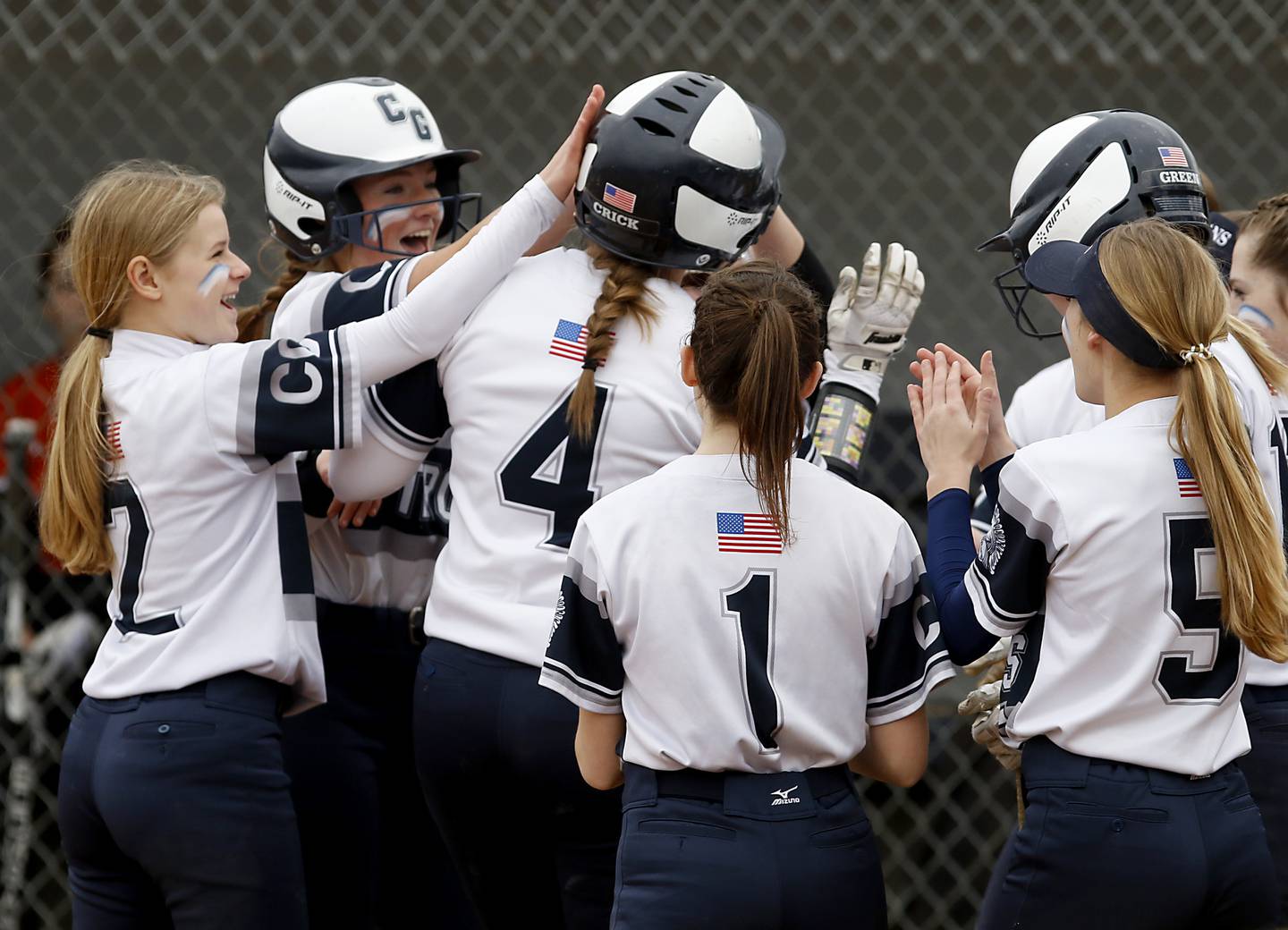 Cary-Grove’s Madilynn Crick is congratulated by her teammates after she hit a home run during a Fox Valley Conference Softball game Monday, May 2, 2022, between Cary-Grove and McHenry at Cary-Grove High School.