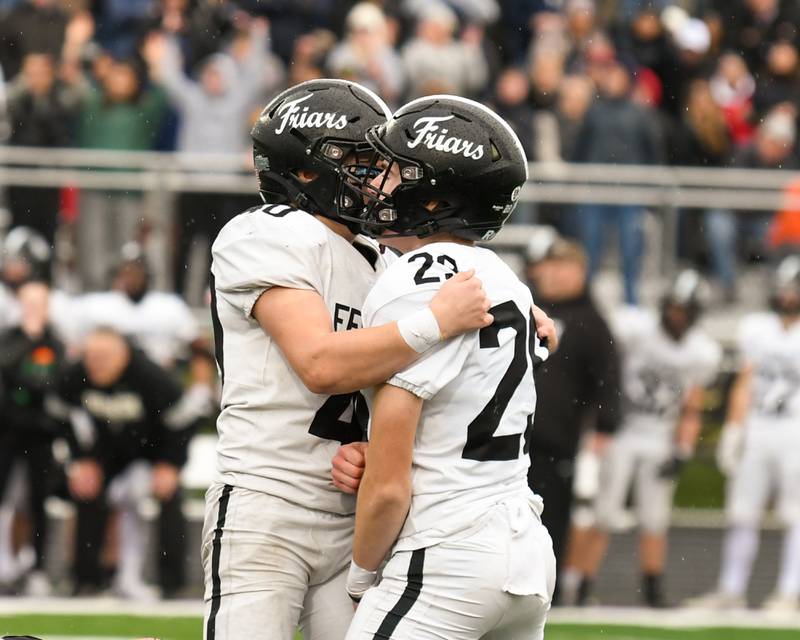 Fenwick's Duffy Monahan, left, celebrates with teammate Fenwick's Noah Sur (29) after Noah kicks a field goal to tie the game agents Downers Grove North during the second week of the class 7A game on Saturday Nov. 9, 2024, held at Downers Grove North High School.