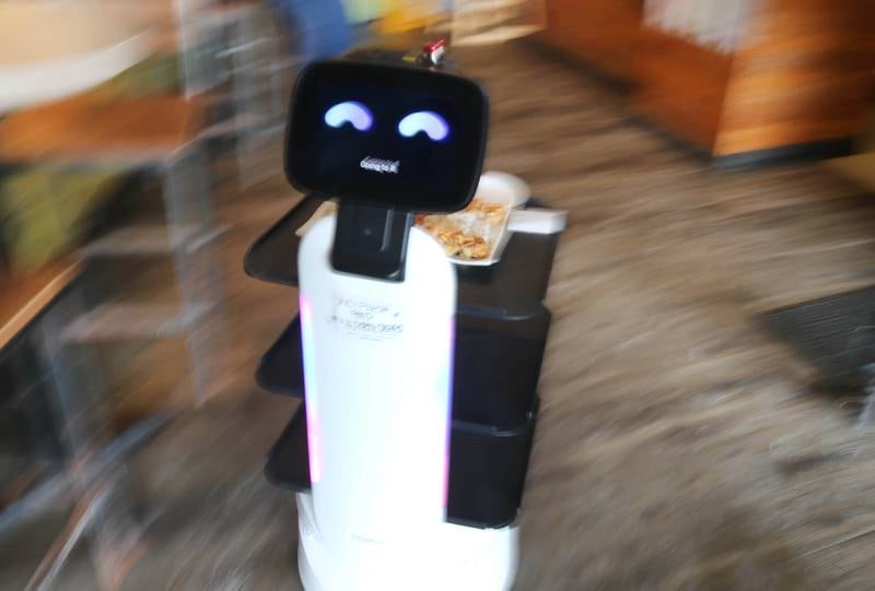 The robot waiter named Mushroom at Fushi Yami hibachi and sushi restaurant hustles an order to a table Friday, Jan. 19, 2024, at the eatery in DeKalb.