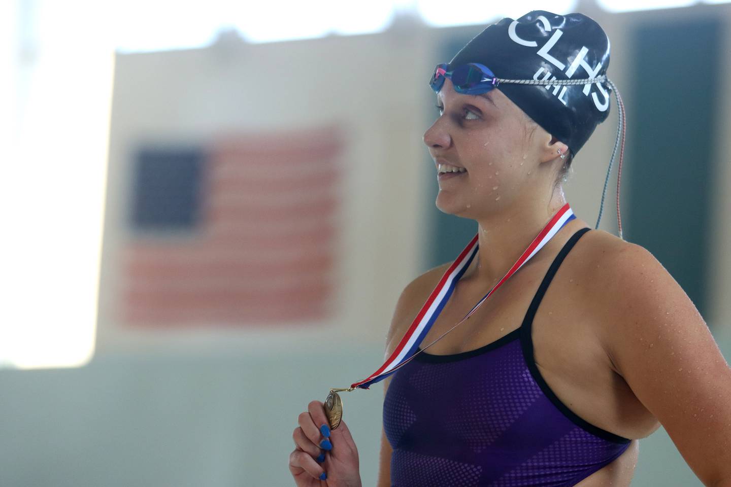 Crystal Lake South co-op’s Abby Uhl displays her medal after winning the 200-yard IM during the Fox Valley Conference Championship Meet at Woodstock North High School on Saturday, Nov. 2, 2024 in Woodstock .