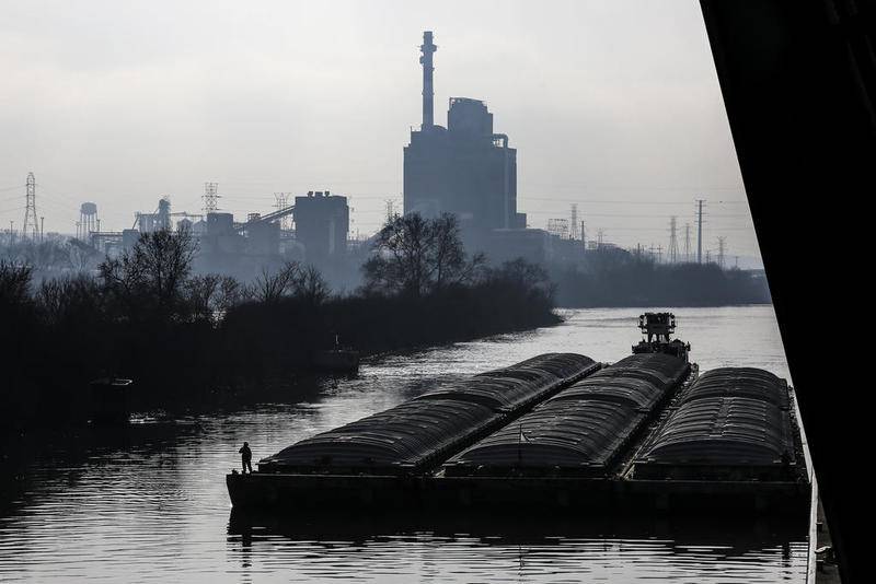 A barge floats down the Illinois River on Friday, Nov. 30, 2018, while navigating through the Brandon Road Lock and Dam in Joliet, Ill.