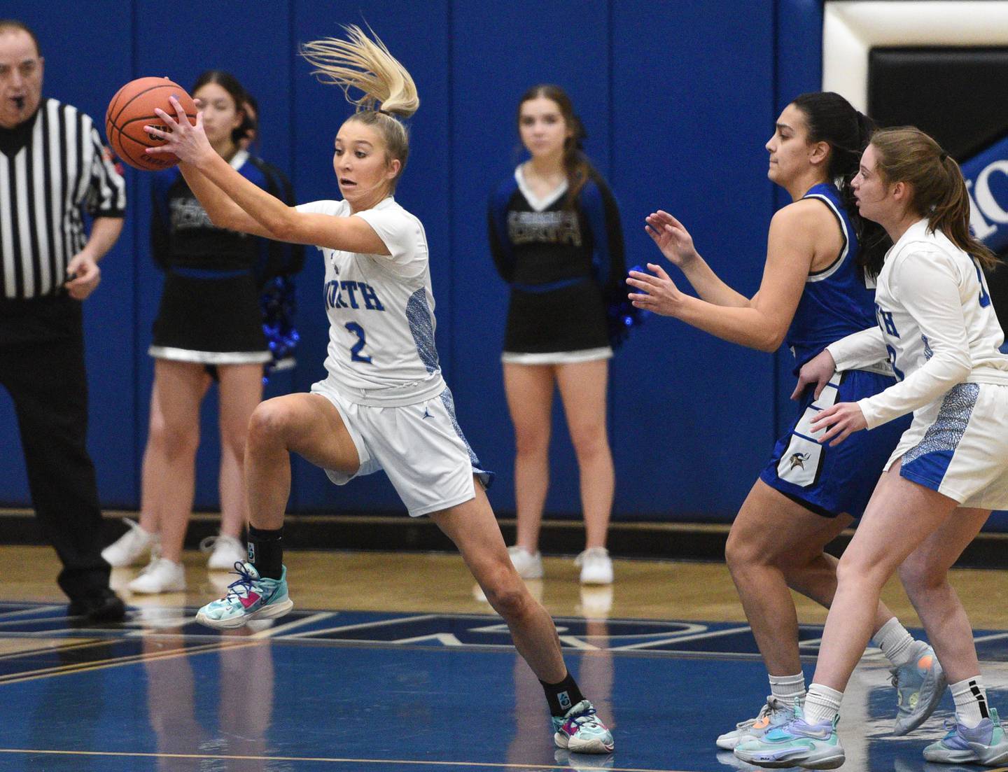 St. Charles North's Reagan Sipla (2) pulls down a rebound during Thursday’s girls basketball game against Geneva in St. Charles.