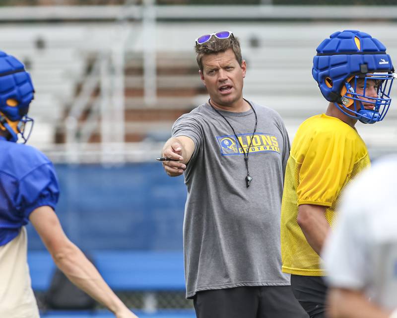 Head coach Jon Beutjer instructs a player at Lyons football practice, Monday, Aug 18, 2025  in Western Springs.