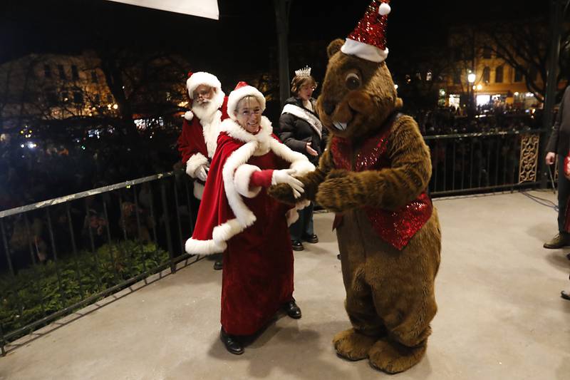 Woodstock Willie dances with Mrs. Claus as the choir sings Christmas carols during the Lighting of the Square Friday, Nov. 25, 2022, in Woodstock. The annual event featured brass music, caroling, free doughnuts and cider, food trucks, festive selfie stations and shopping.
